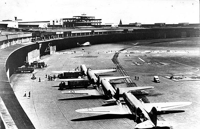 Four C-47 aircraft lined up at Templehof Airport in Berlin getting loaded with vital goods.