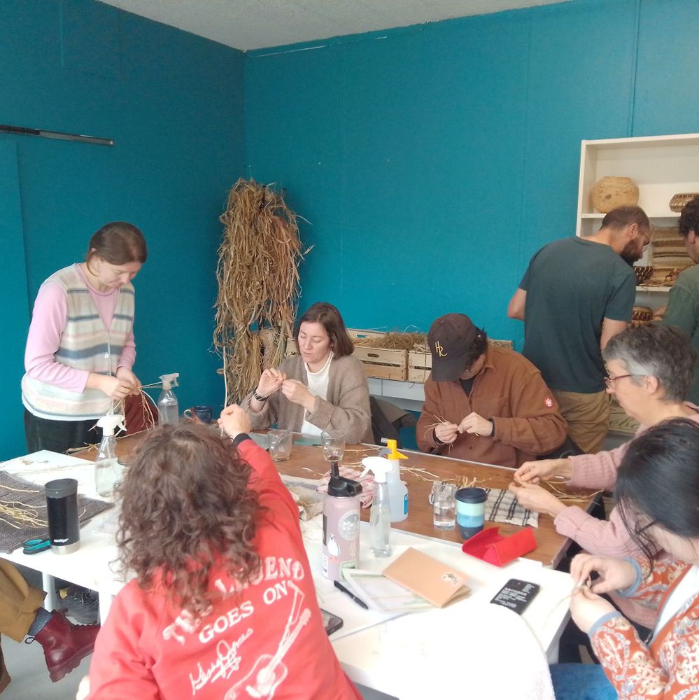 People sitting around a table during a workshop in a room with blue walls