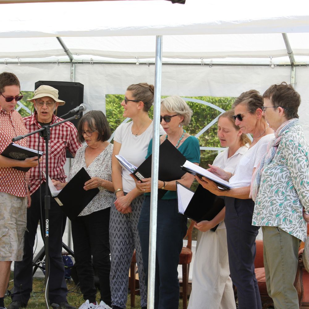 A choir singing in a marquee
