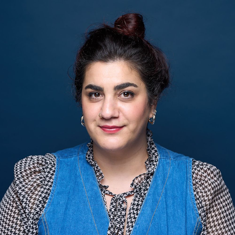 Headshot of Ruba Asfahani, looking into the camera, smiling slightly