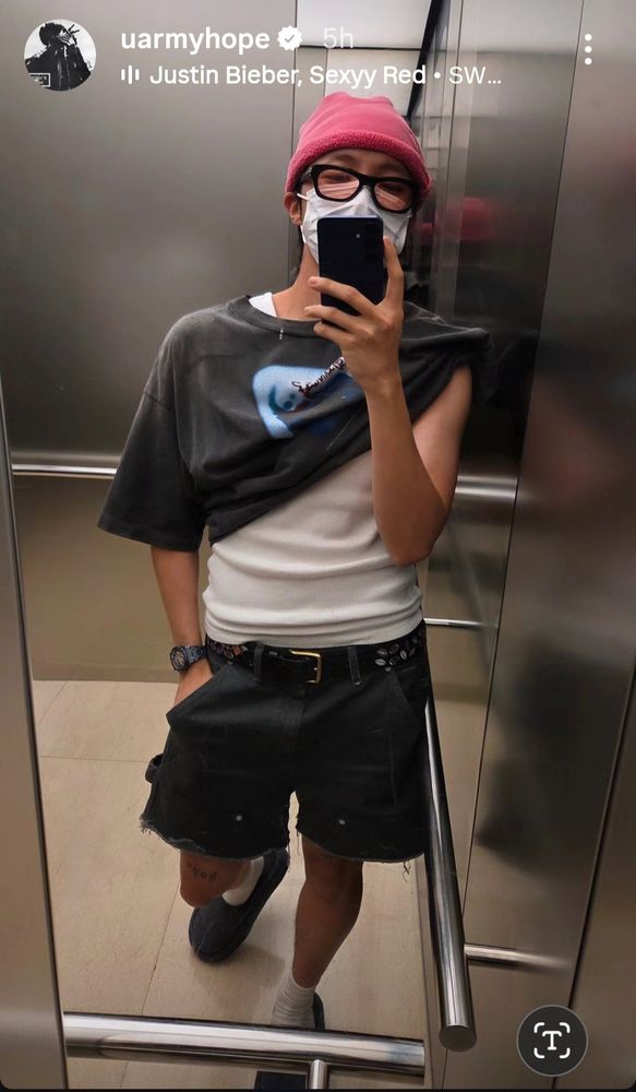 J-Hope in an elevator selfie. Black shorts - gotta let those new tats breathe. White tank top peeks out under a grey to that is half on. So not quite chapter 2 level of skin showing. Chapter 1.5 maybe?