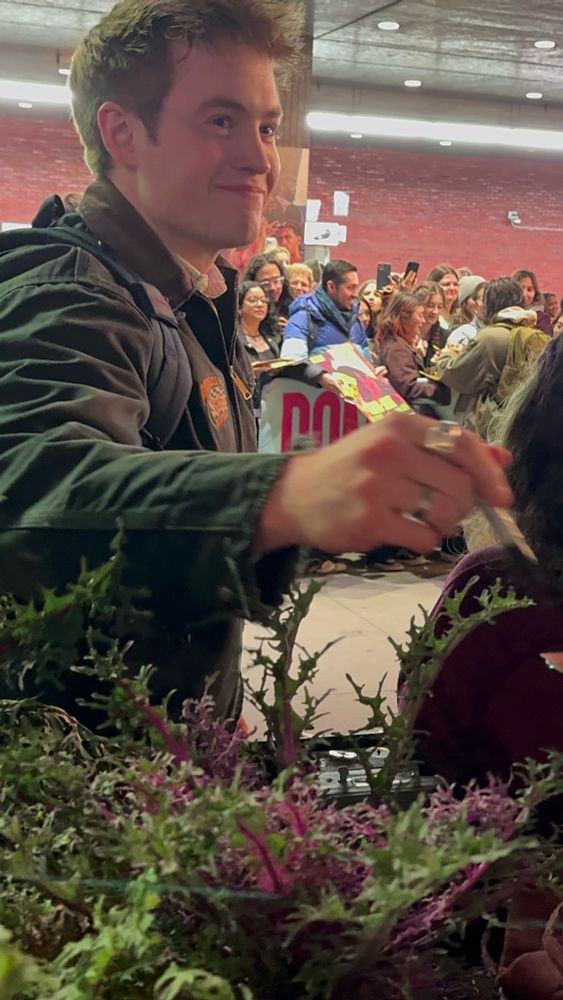 a smiling kit connor signing autographs at stage door after romeo and juliet in new york city