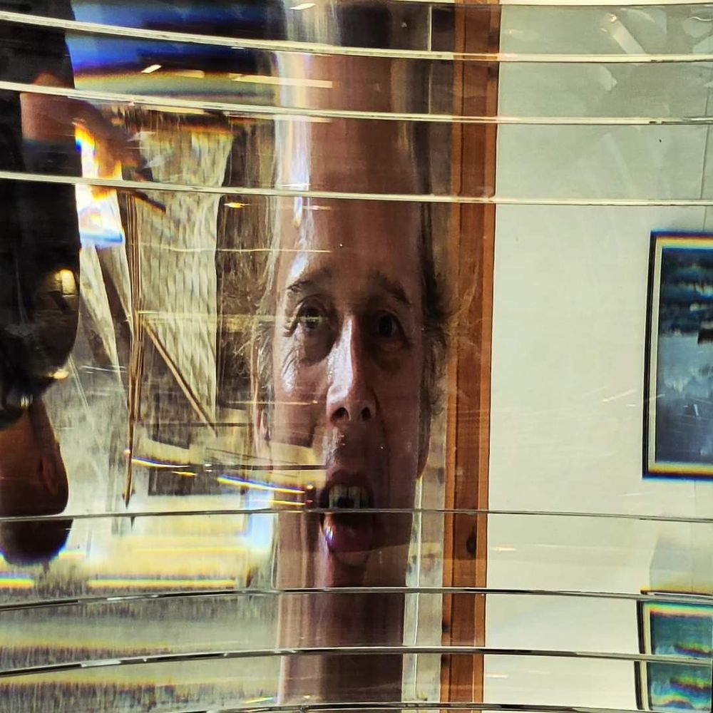 My head seen through the lens of a lighthouse lamp diffuser