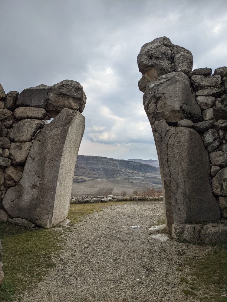 Looking out through a stone gate at the historical site of Hattuşa, the ancient capital of the Hittite kingdom. 