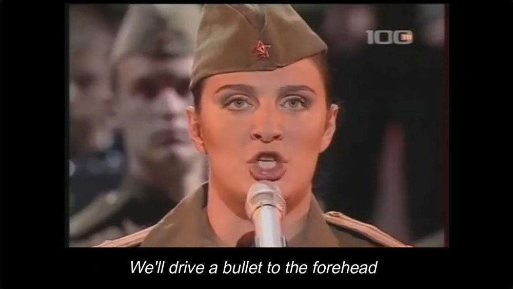Elena Vaenga singing The Sacred War, a soviet song. The subtitle reads "We'll drive a bullet to the forehead..."