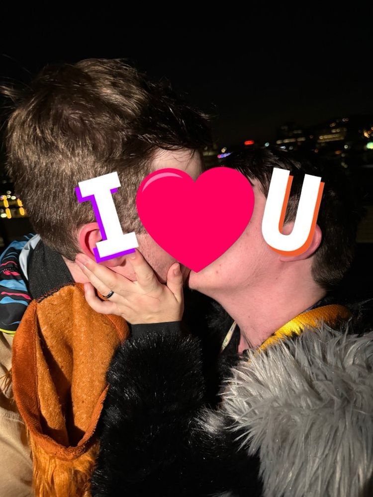 Darkstar and Blanc kissing with text reading “I ❤️ U” censoring their faces. 