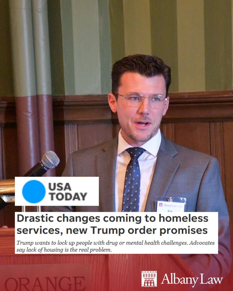 Photo of Pat Wildes, Director of the Government Law Center at Albany Law School, speaking into a microphone at a lectern. Pat has fair skin, short dark brown hair, and wears glasses. He is wearing a gray suit with a white button-up shirt and blue tie. 
Overlay: USA TODAY Logo, with screenshot of article headline: "Drastic changes coming to homeless services, new Trump order promises," followed by "Trump wants to lock up people with drug or mental health challenges. Advocates say lack of housing is the real problem."
Albany Law logo