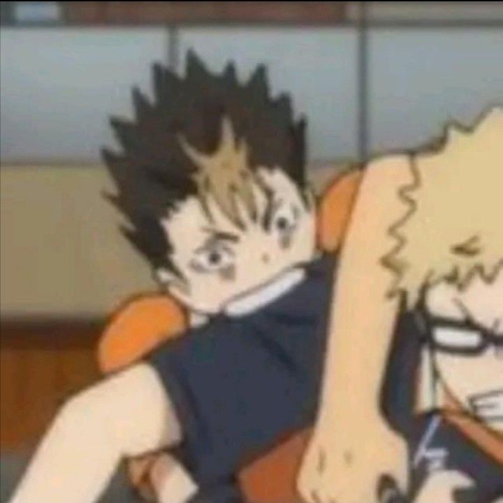 A zoomed in screenshot of Nishinoya, a character from the sports anime Haikyuu, biting Tsukishima in the arm.
