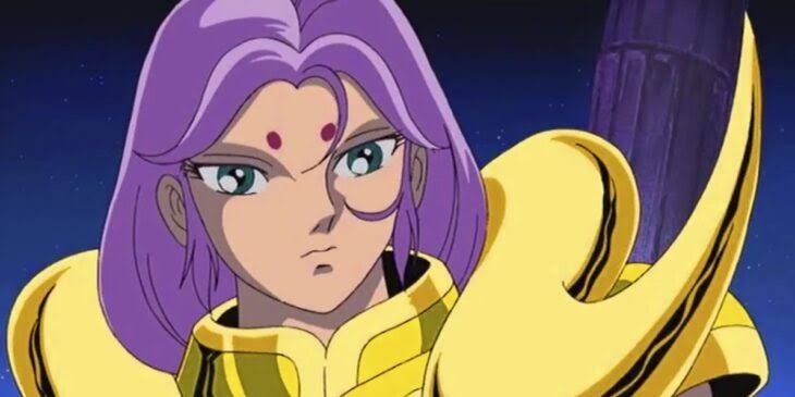 Imagem do rosto do Mu de Áries de cavaleiros do Zodíaco.
Ele tem cabelo roxo e duas bolinhas em cima da sobrancelha 