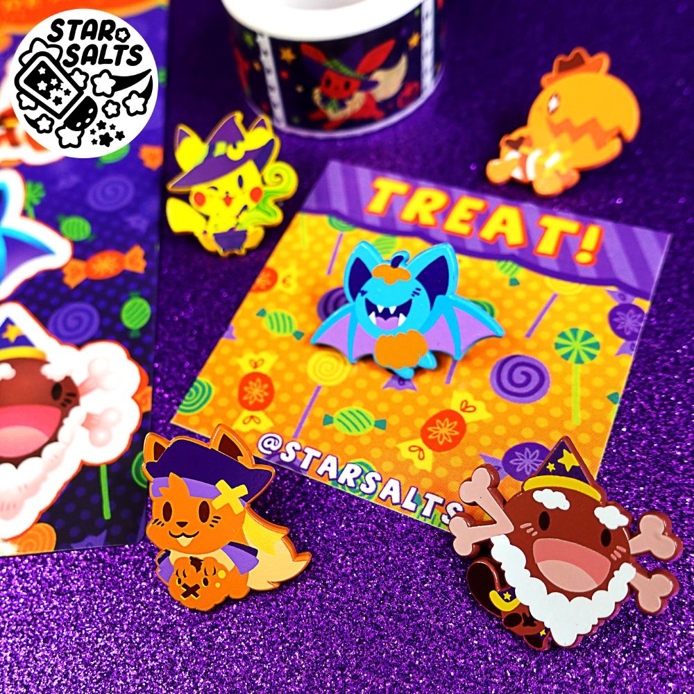 Halloween Pokemon soft enamel pins on a purple background with stickers, washitape, and an orange pin backing slip.