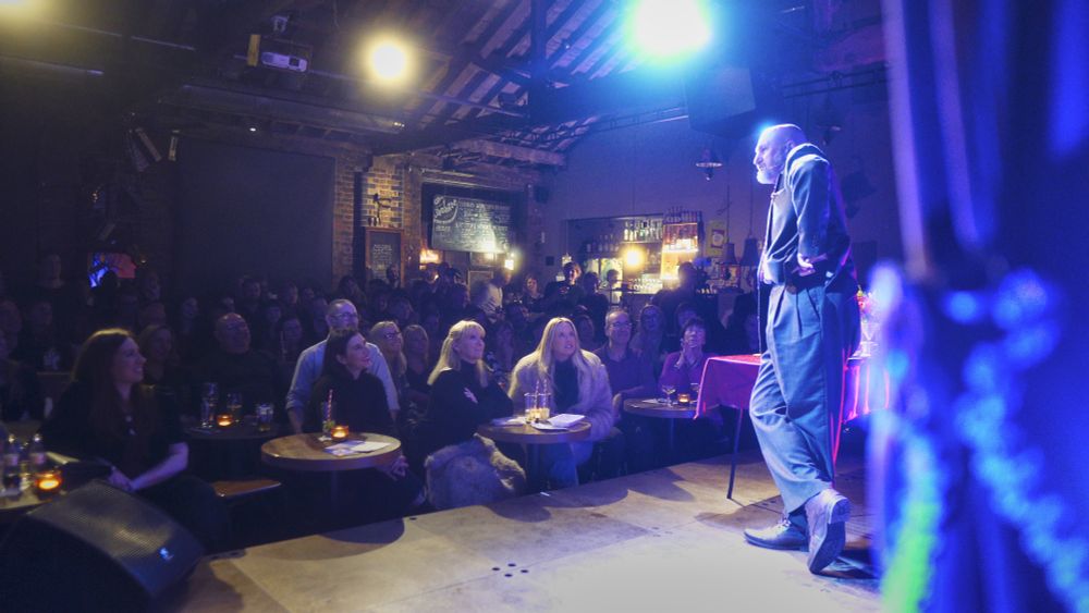 me, in a lovely vintage ralph lauren suit, doing a grumpy face on stage in a packed cabaret club. Happy place.