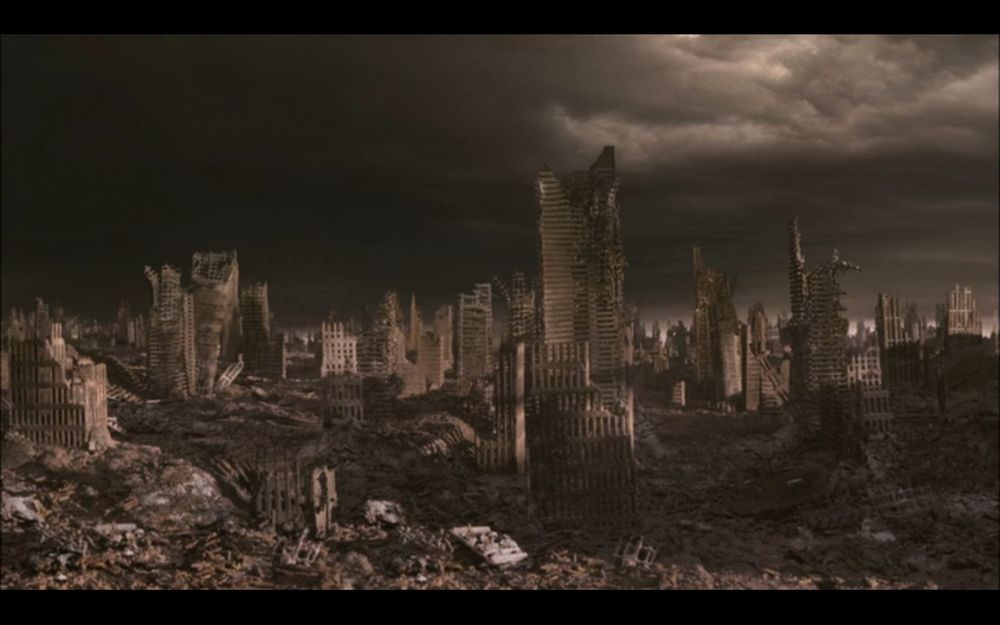 Ruins of a city that looks like it's been bombed, against a dark and gray sky.