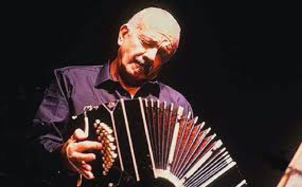 Color picture of Astor Piazzolla in his later years, playing the bandoneón.