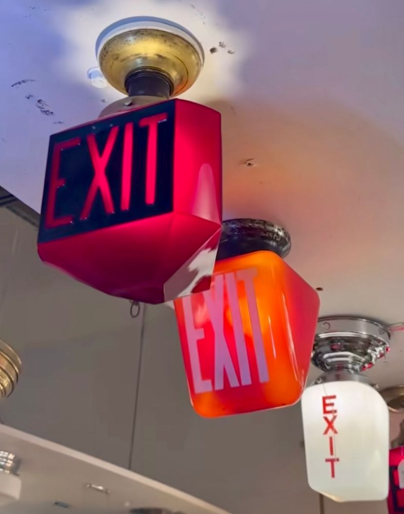 Antique ceiling attached exit light signs. 