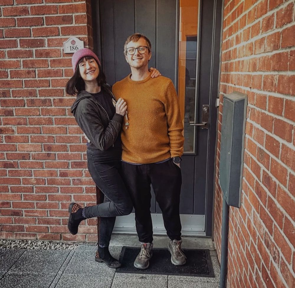 A couple stood outside the door of their new home 