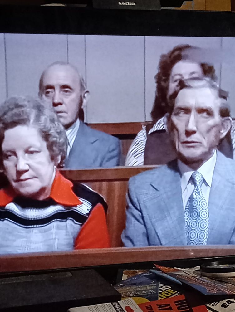 A thin faced man giving the side-eye in an edition of Granada Television's 'Crown Court'.
