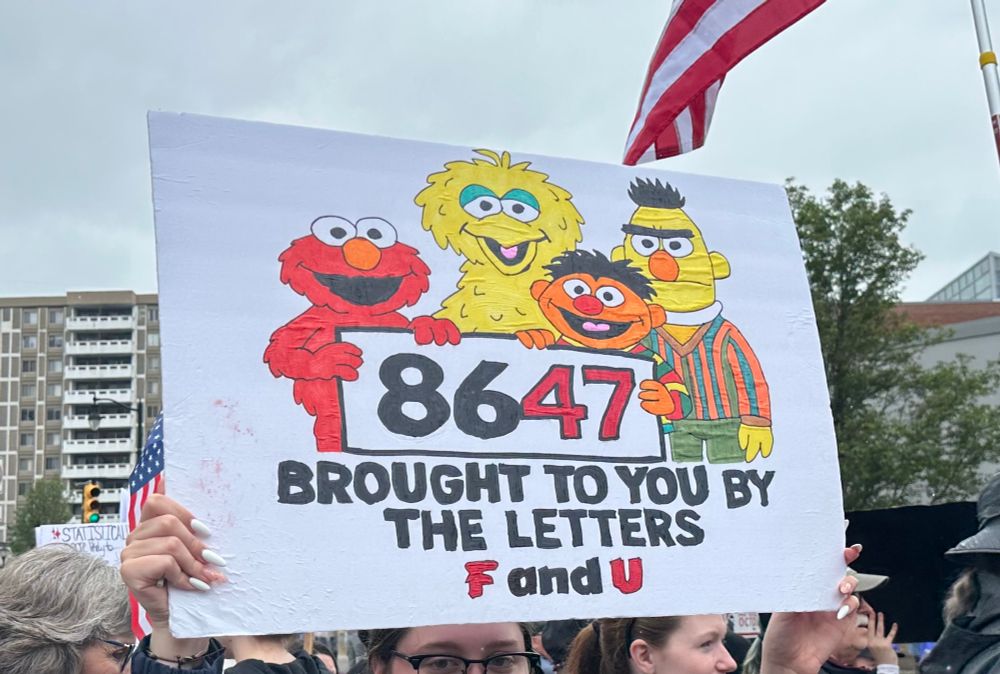 Protest Sign:  8647 brought to you by the letters F and U.  Featuring Elmo, Big Bird, Bert and Ernie from Sesame Street.