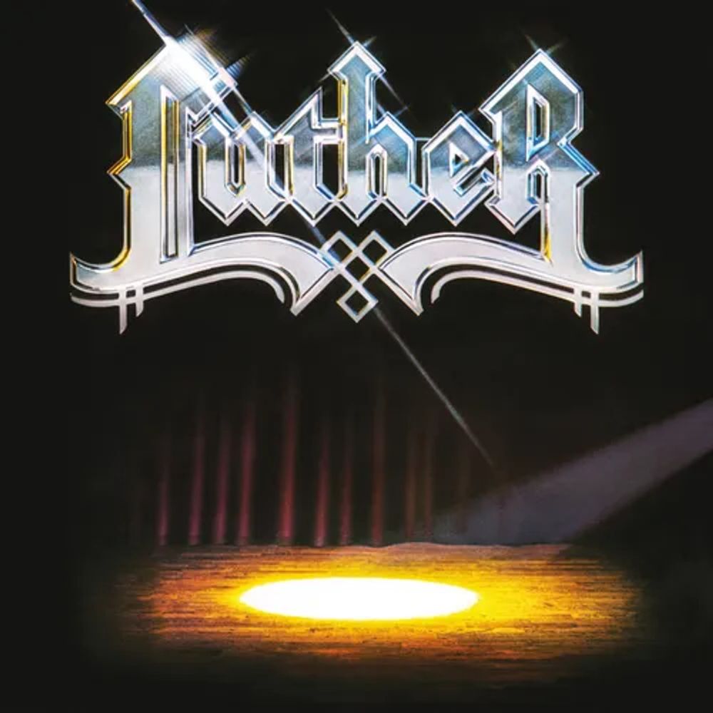Album cover for 'Luther' featuring the name in shiny, metallic Gothic-style lettering at the top, with a spotlight shining on an empty wooden stage against a dark background with faint red curtains