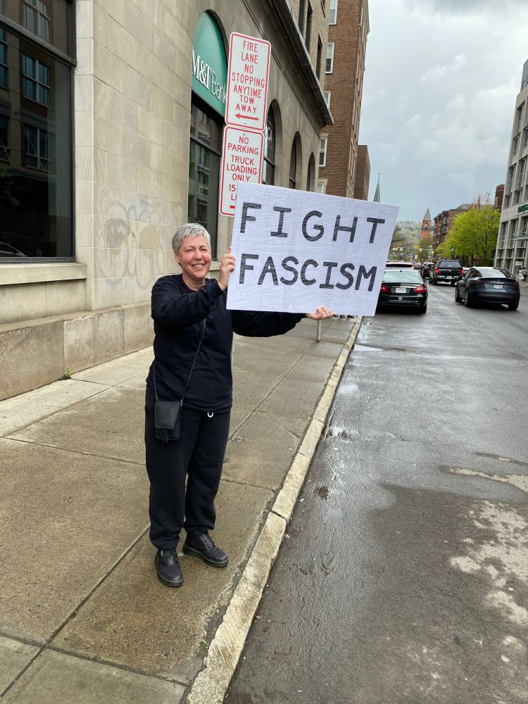 Protester in Ithaca New York holding a sign that says Fight Fascism