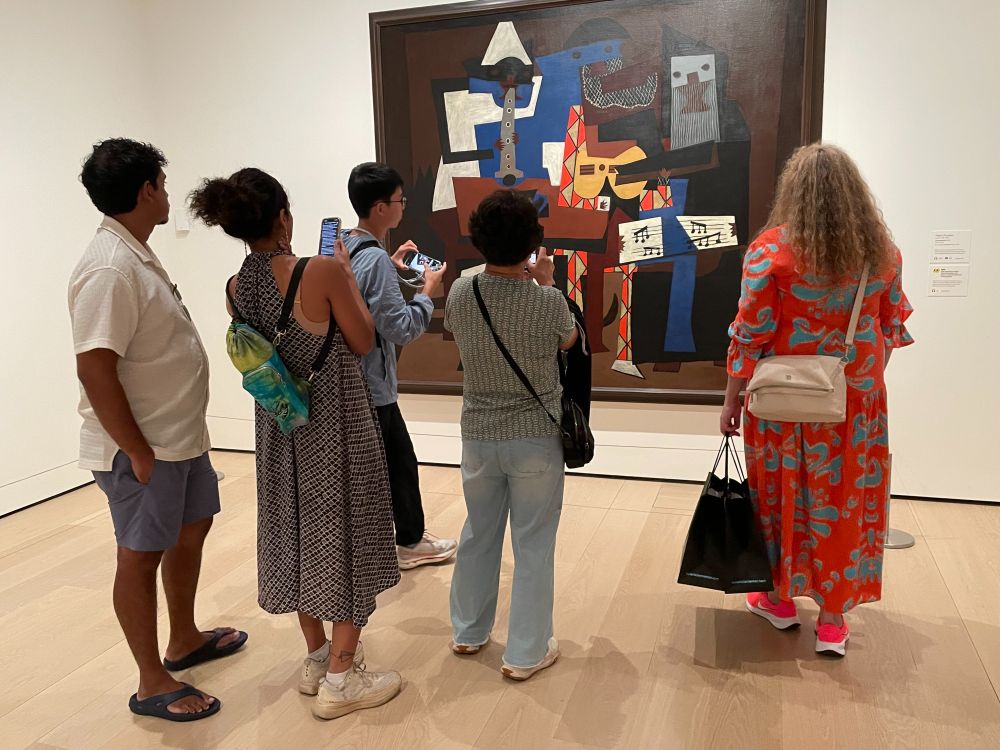 At the Museum of Modern Art in New York City visitors take in Picasso's "Three Musicians" painted in 1921. 