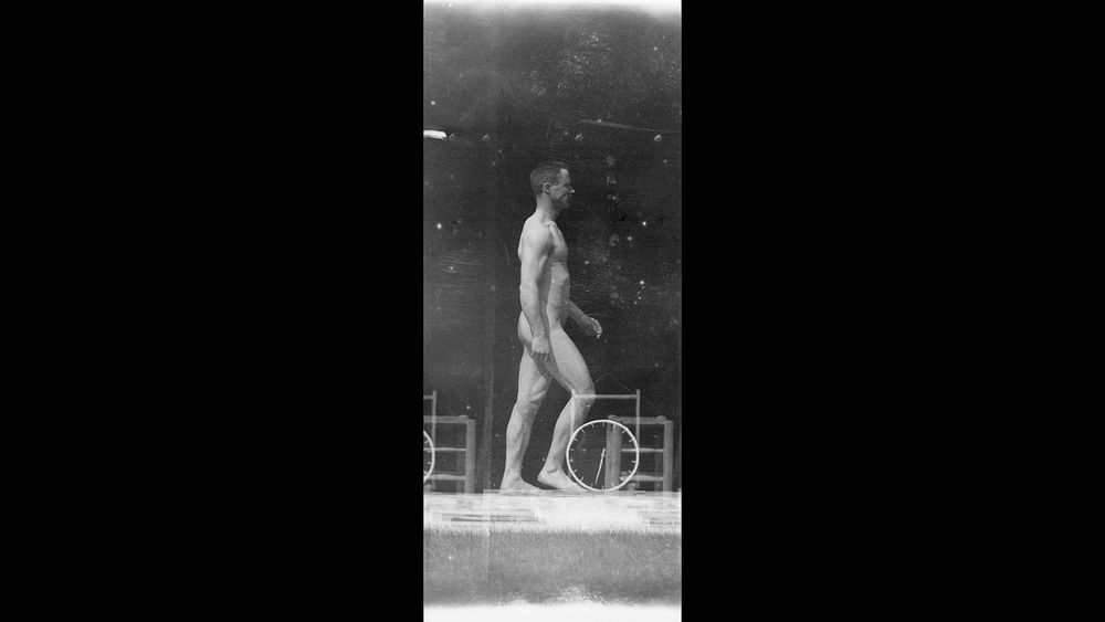 a nude man walks