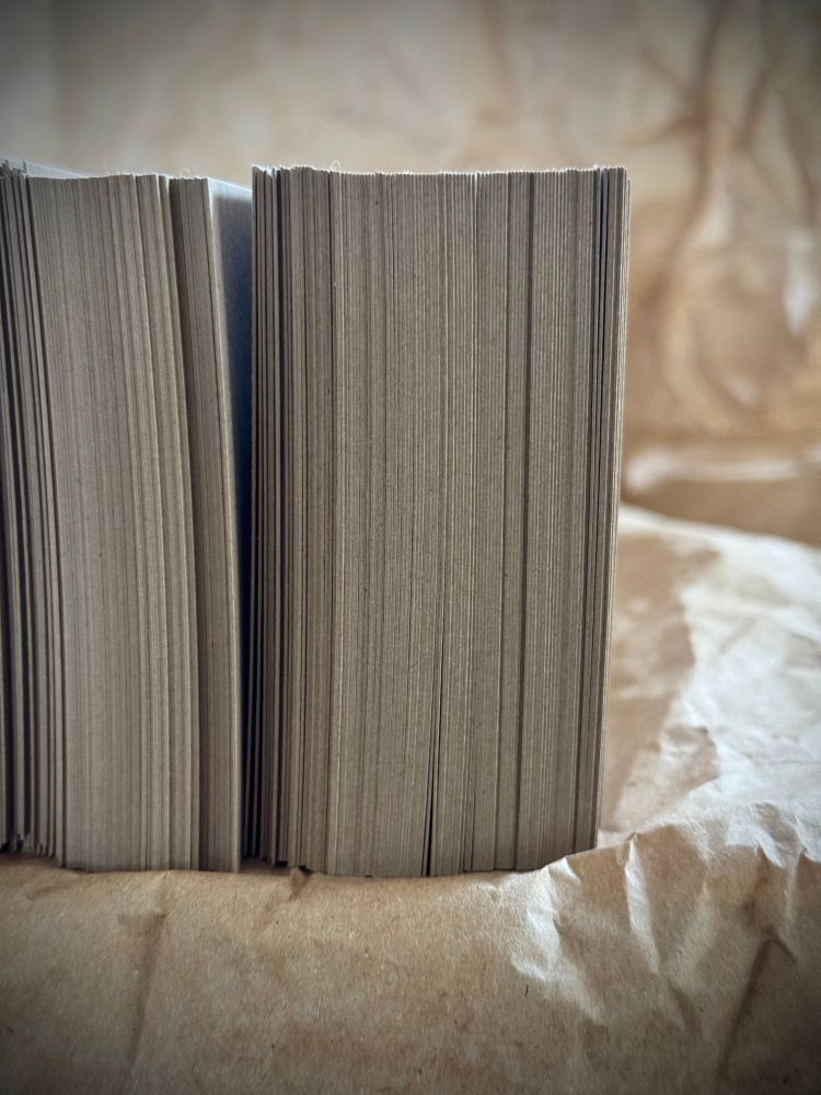 Stack of Kraft card on its side, edge on, on crumpled tissue paper