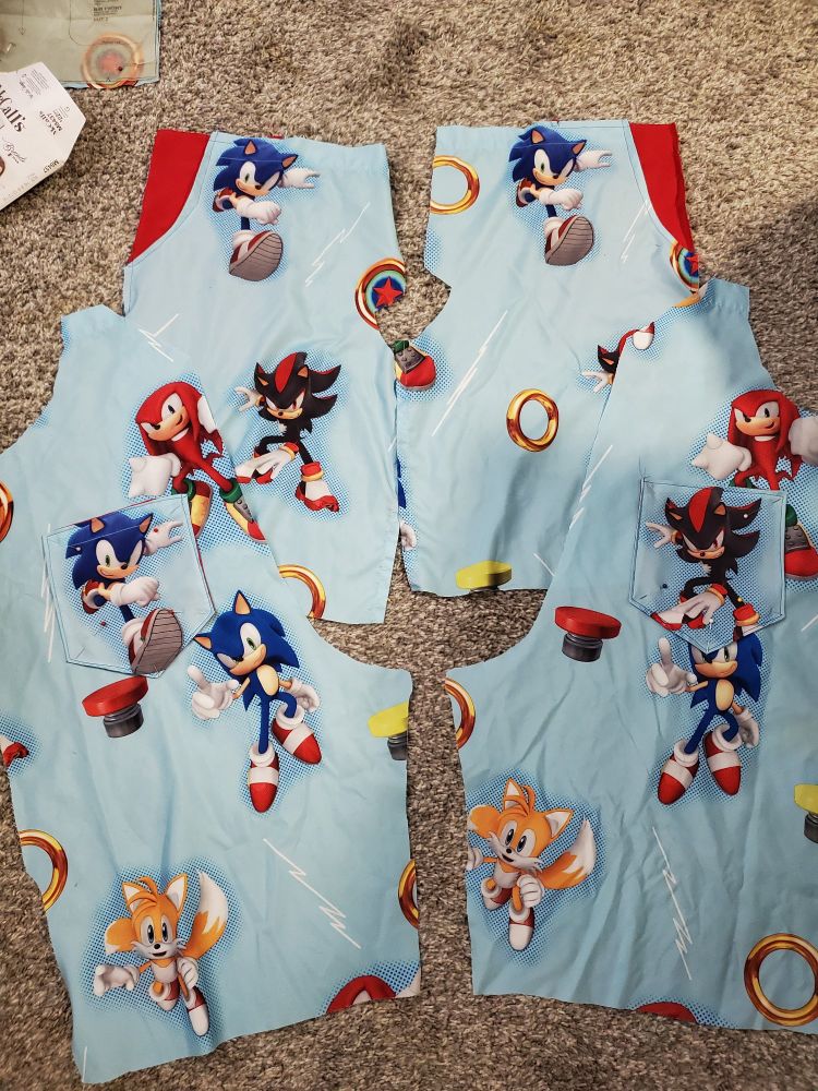 4 pants panels laid out with pockets pinned onto them