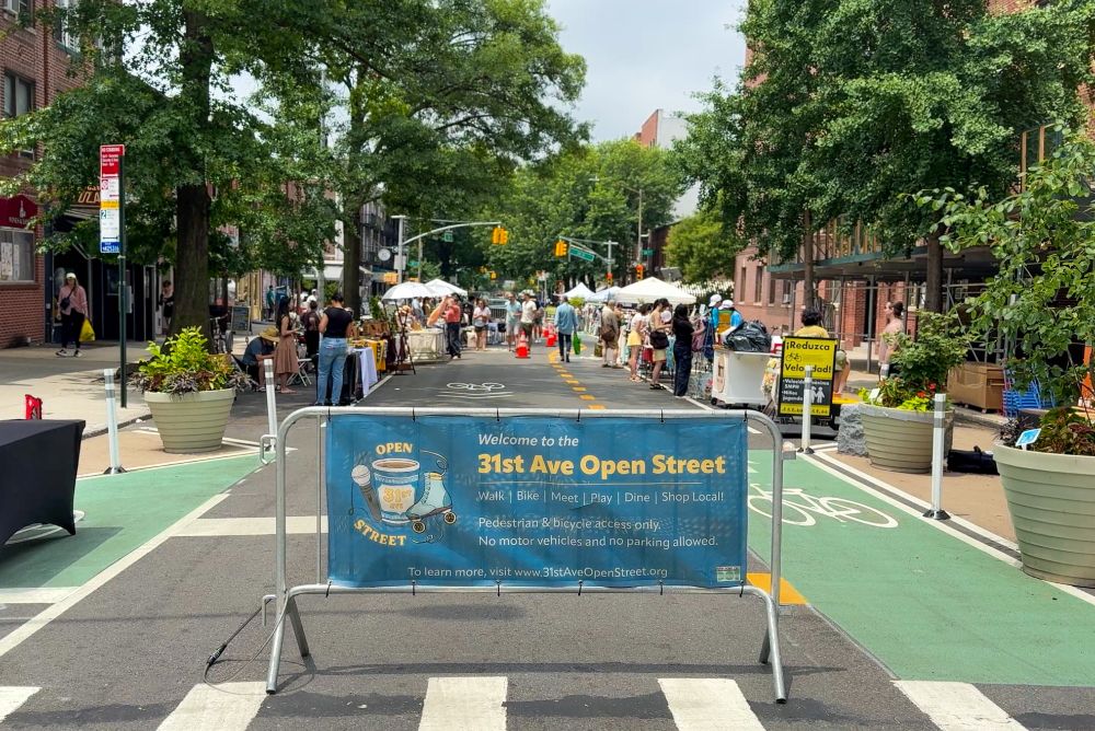 The newly redesigned 31st Avenue, while the Open Street along the corridor is in operation, showing a french barricade and a crowd of people behind it. 