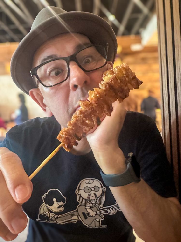 Simon eating Yakitori