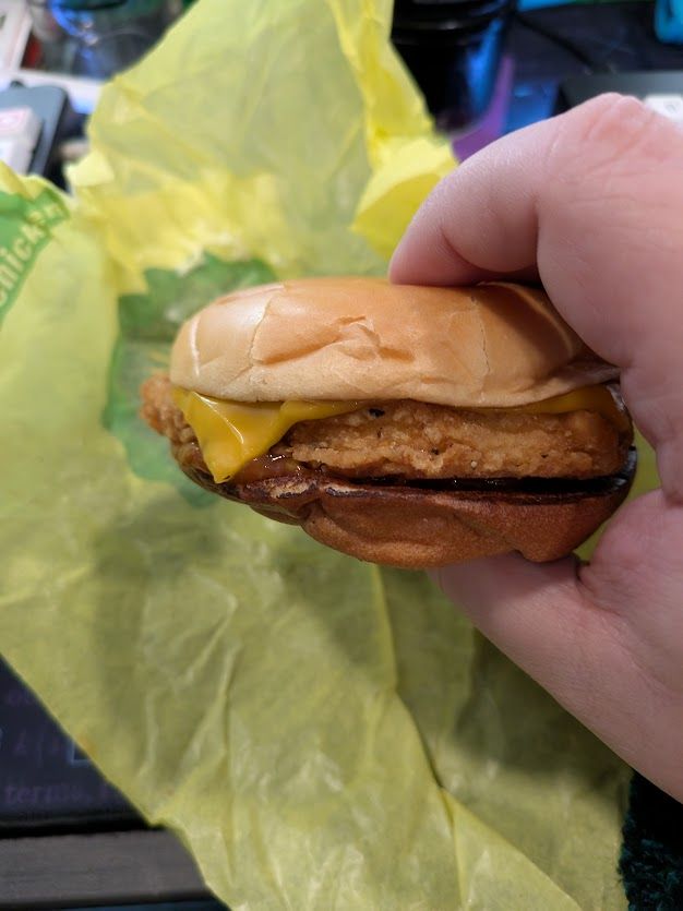 The McChicken from the previous image, unwrapped and with the salsa from the packet applied under the chicken patty.