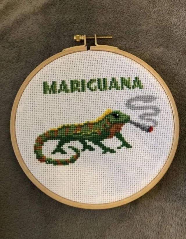 A circular needle point that says MARIGUANA with an iguana smoking a joint