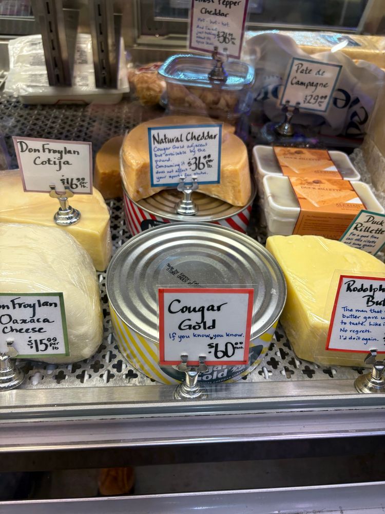 cougar gold cheese in the case at the Cheese Box in pike place market
