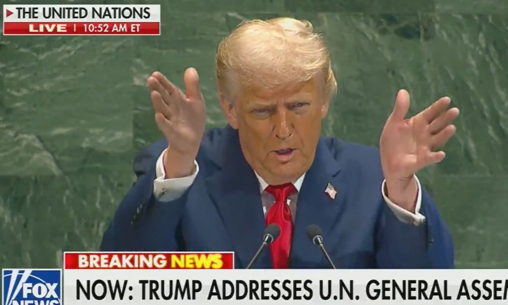 Screenshot of President Donald Trump giving a speech at the podium of the UN in New York on September 23 2025 with his hands held up in front of him.