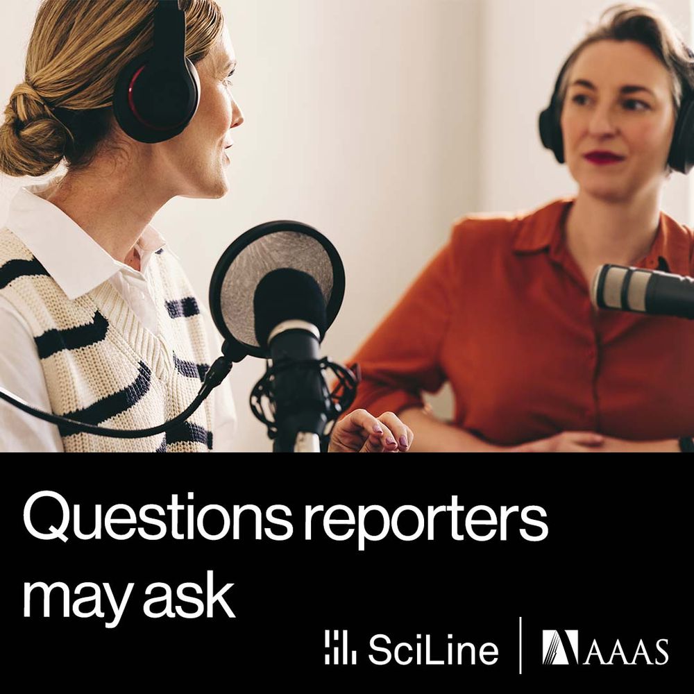 Two women sit in conversation in front of two microphones