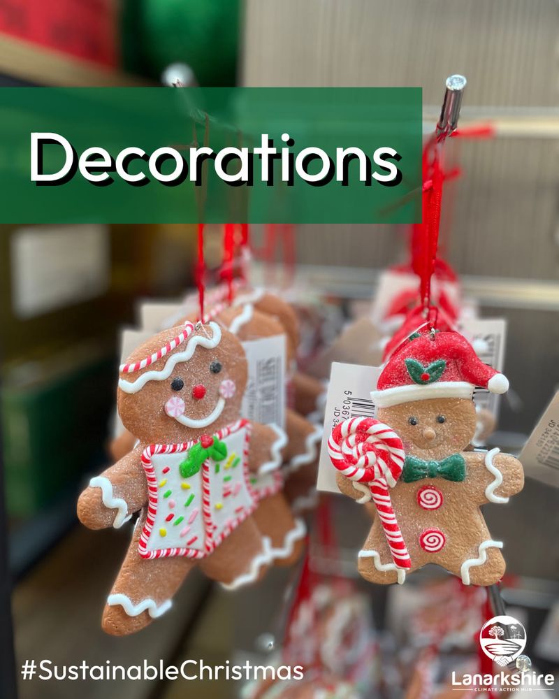 Background image shows a close up of two gingerbread Christmas tree decorations hanging on a hook in a shop.