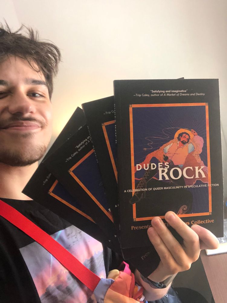 selfie of me holding up 4 copies of DUDES ROCK