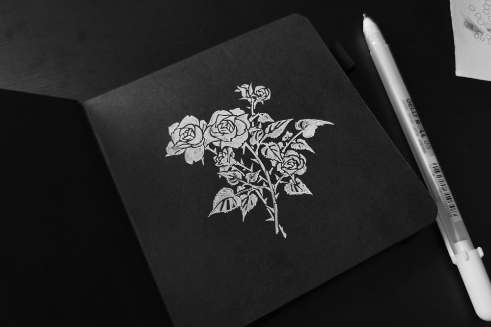 Roses in white ink on black paper.