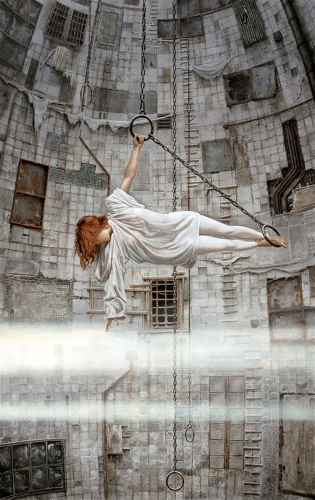 In a vast chamber lined with square concrete panels, a woman grips an iron ring to hang suspended in a sideways T. A taut chain extends from the ring on a diagonal down to another metal loop where she anchors her bare feet. Gravity tugs on her fiery orange hair as she reaches down to touch a broad band of mist. The hood of her loose white top spills down as do both sleeves, one bunching at the shoulder to expose her arm—her torso prevents it from falling farther—while unobstructed the other sleeve billows loosely. There is some curvature to the wall behind her, which tapers inward at the top. Boards are tacked in staggered lines extending ladder-like up the wall. A grungy tactile delight, the place looks weathered with tattered cloth draping the concrete in places. A variety of openings are covered by rusty grates or metal plates.

