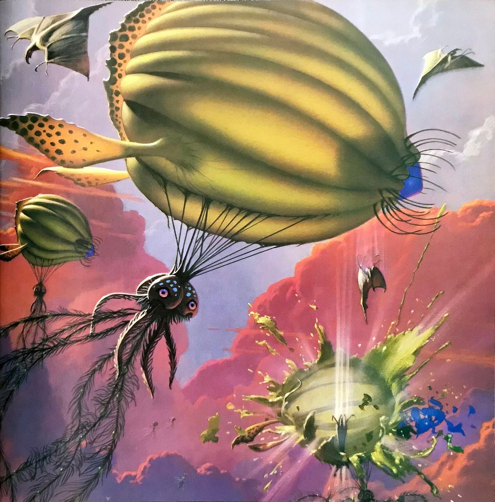 In the clouded skies of Jupiter, Swordtails attack Jellyblimps. The Swordtails resemble aquatic rays, forming broad triangles as they glide with wings wide. They drop tail down to dive bomb the black tentacled cephalopods dangling from green blimp-like air sacs on a series of black cords.