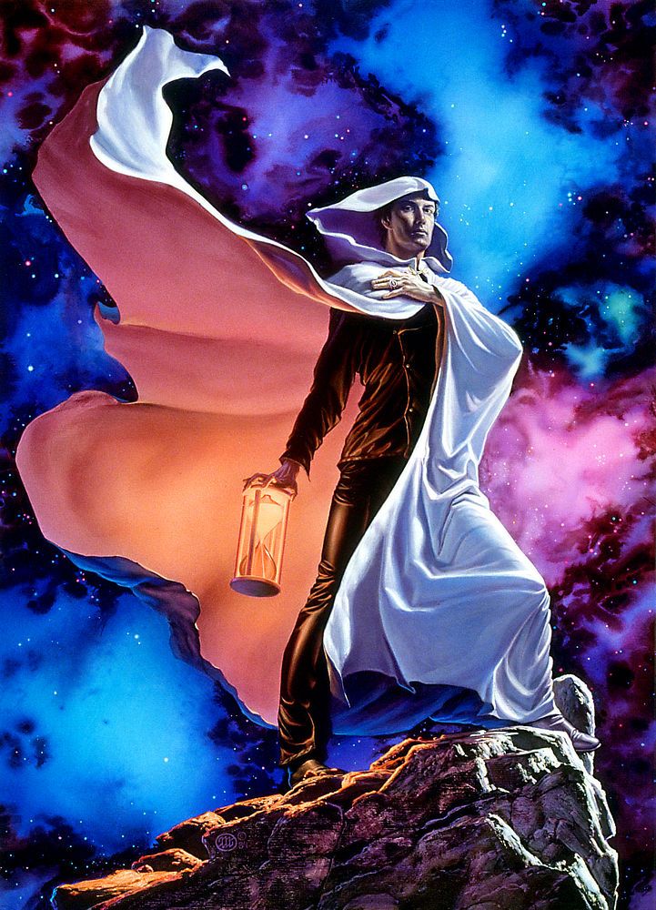 With regal bearing, a man in a hooded white cloak stands against a celestial backdrop of vibrant pink, blue and purple. He holds one hand across his chest as his cloak flutters to reveal his black leather shirt and trousers beneath. In his other hand he grips the top of an hourglass turned so the sand is situated in the top bell to spill down. The sand glows and tints the inside of his cloak peach.