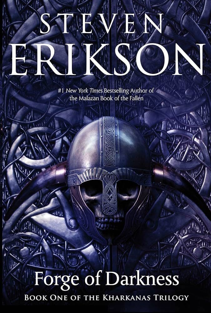 Forge of Darkness by Steven Erikson.
A skull in an iron helmet lays on an intricate metalwork background 