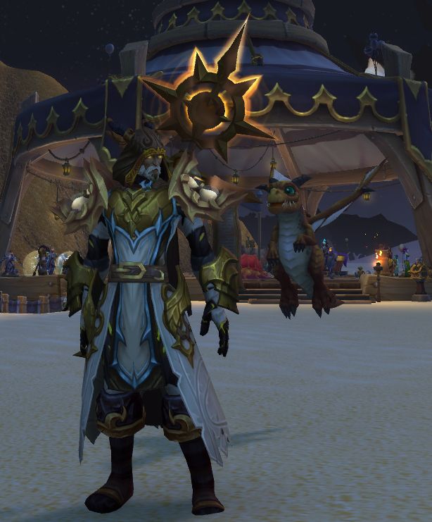 An evoker at the Caverns of Time celebration, in bronze, white, and black armor with an Arathi staff. 