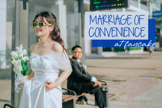 Photograph of a young Vietnamese couple in a sunny urban environment, with added text: Marriage of Convenience, at Fancake. A bride in a white dress and sunglasses leaves her groom behind at a bus stop. The bride is smiling and carrying a bouquet of lilies as she hikes up the long skirt of her dress and walks away. The groom is in the background, wearing a dark grey suit and sitting on a bench. He's blurry, but it looks like he might be smiling at her.