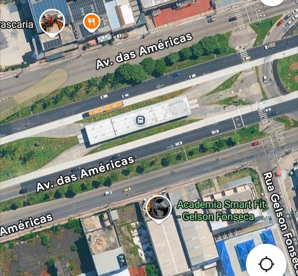 Satellite image of brt station in Rio with passing lanes that allow for express services that bypass the station. A bus is visible bypassing the station.