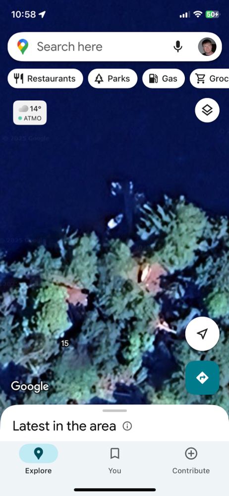 Google maps imagery showing sailboat tied between dock and shore. 