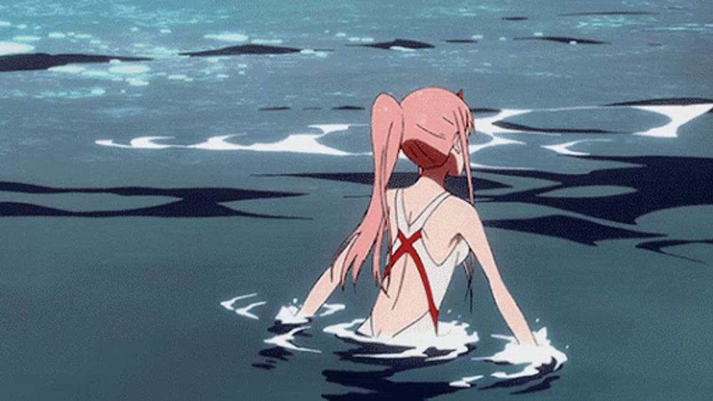 a girl with pink hair is in the water