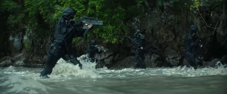 screenshot from the an Alien: Earth Trailer, of military operatives wielding weapons shown in a movie set 57 years later.