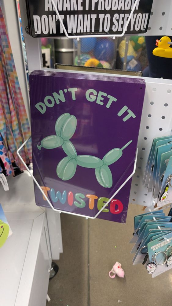 novelty public notice sign (floppy metal) for sale at five bel°w, depicting a twisty balloon folded into a dog shape, ringed by the words DON'T GET IT TWISTED 