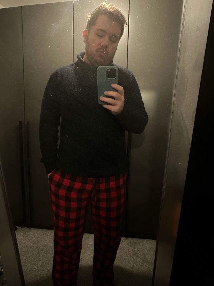 another selfie in classic needs for validation: black high neck jumper with red and black tartan checked trousers taken in a dusty AF mirror