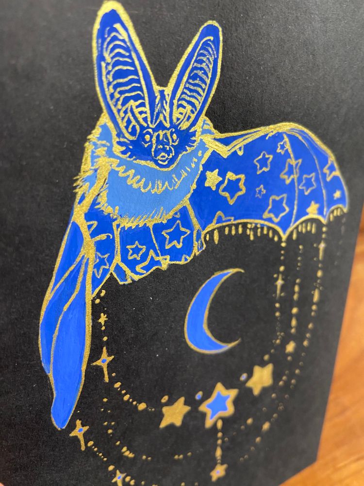 Gouache painting of a bat on black nova series paper.